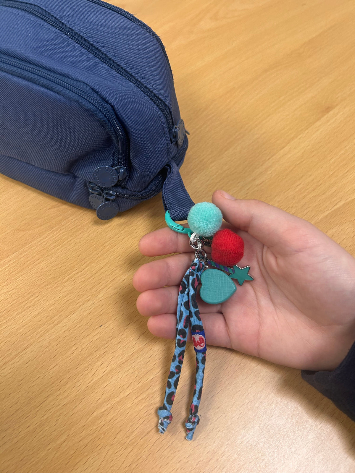 hand holding WITH YOU clip-on, separation anxiety in school